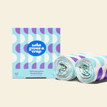 Two rolls and a box of Who Gives a Crap medium recycled garbage bags with purple and blue packaging
