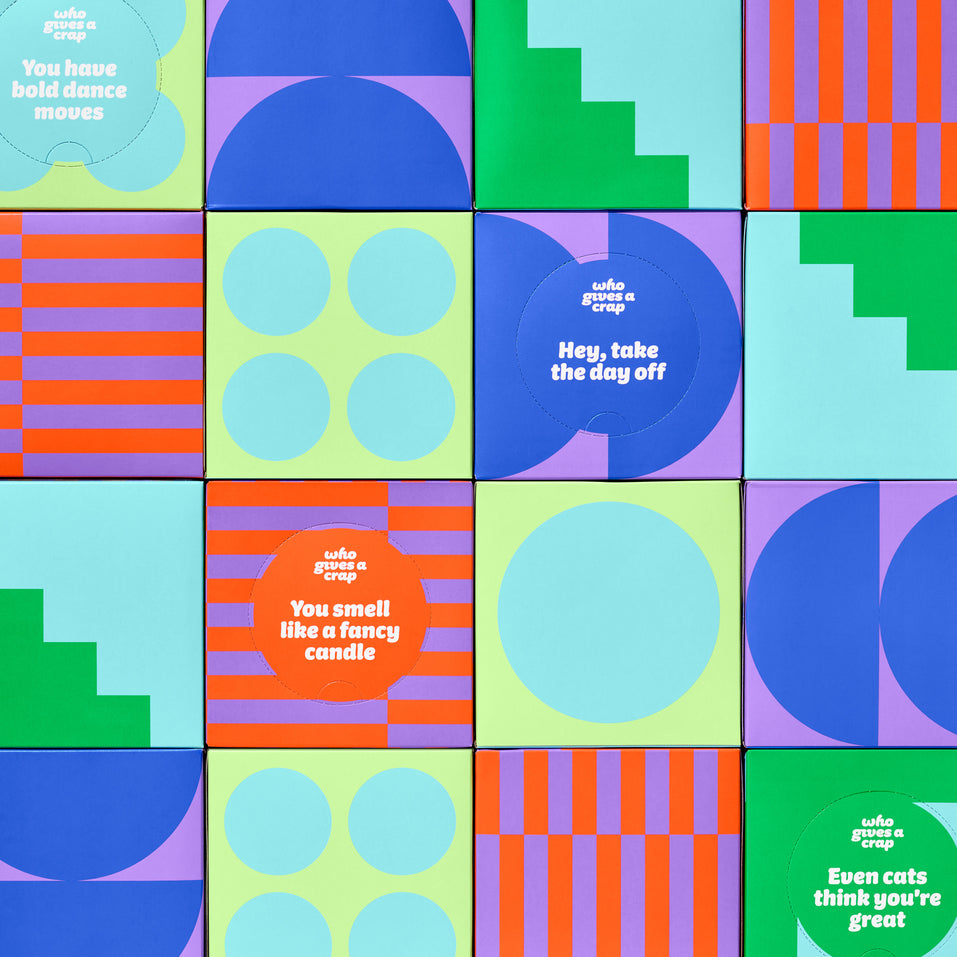 Stacked wall of colourful Who Gives a Crap tissue boxes