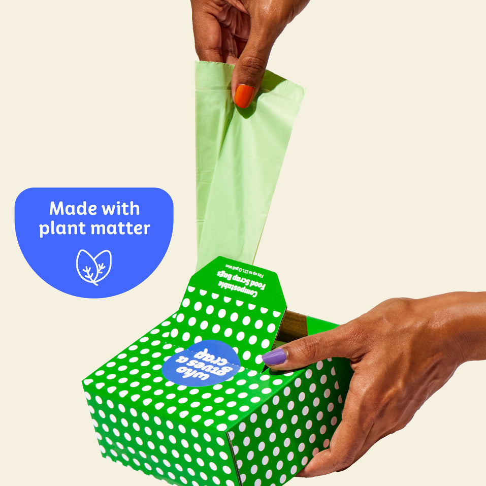 Who Gives a Crap compostable rubbish bag being pulled out of the box with sticker over image that says made with plant matter