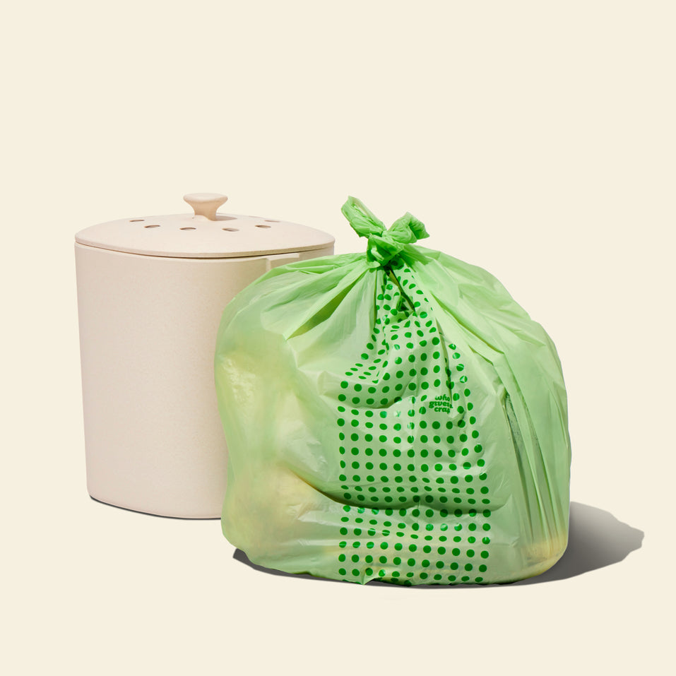 Two rolls and a box of Who Gives a Crap compostable rubbish bags with green packaging