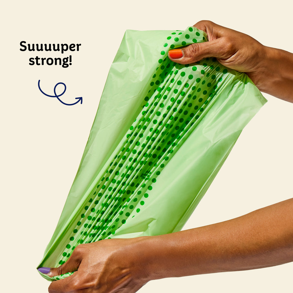 Who Gives a Crap compostable rubbish bag being pulled by a hand to show how strong they are with text over image that says super strong