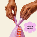 Who Gives a Crap recycled dog poo bag being tied at the top by two hands with text over image that says super strong