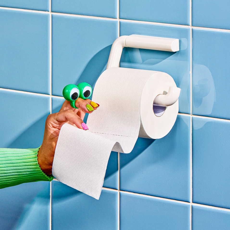 Person pulling at a naked toilet paper roll.