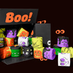 Open black box packed with Halloween-printed bamboo toilet paper rolls in orange, purple, green and white. Box reads 