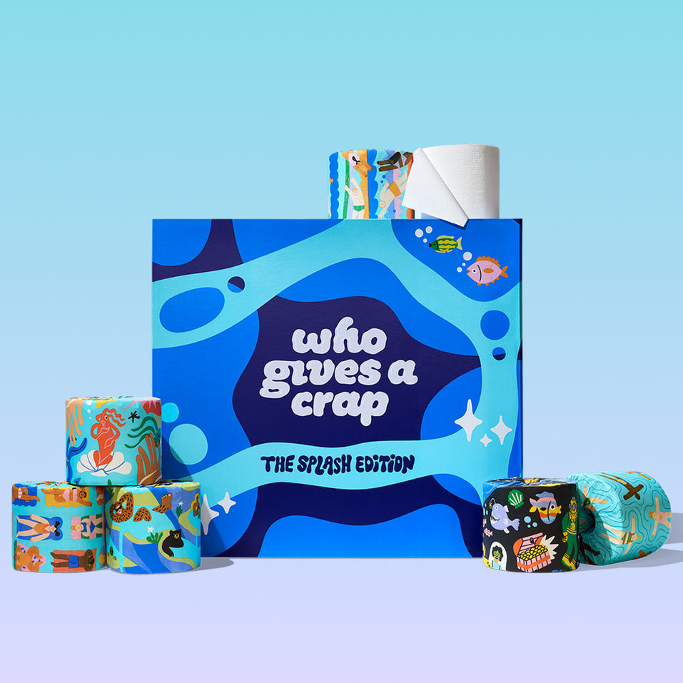 The Who Gives A Crap Splash Edition box surrounded by a collection of illustrated bamboo toilet paper rolls, each featuring unique water-themed artwork, on a light blue background