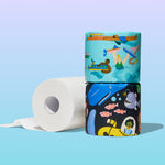Two stacked Who Gives A Crap Splash Edition illustrated rolls beside an unrolled white bamboo toilet paper roll, showing water activities and deep sea creature designs