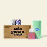 Bundle of Who Gives a Crap products with recycled toilet paper, paper towel and tissues around a shipper box.
