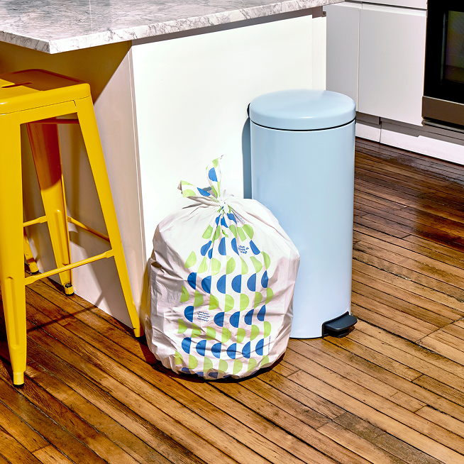 Who Gives a Crap large recycled rubbish bag sits full next to kitchen