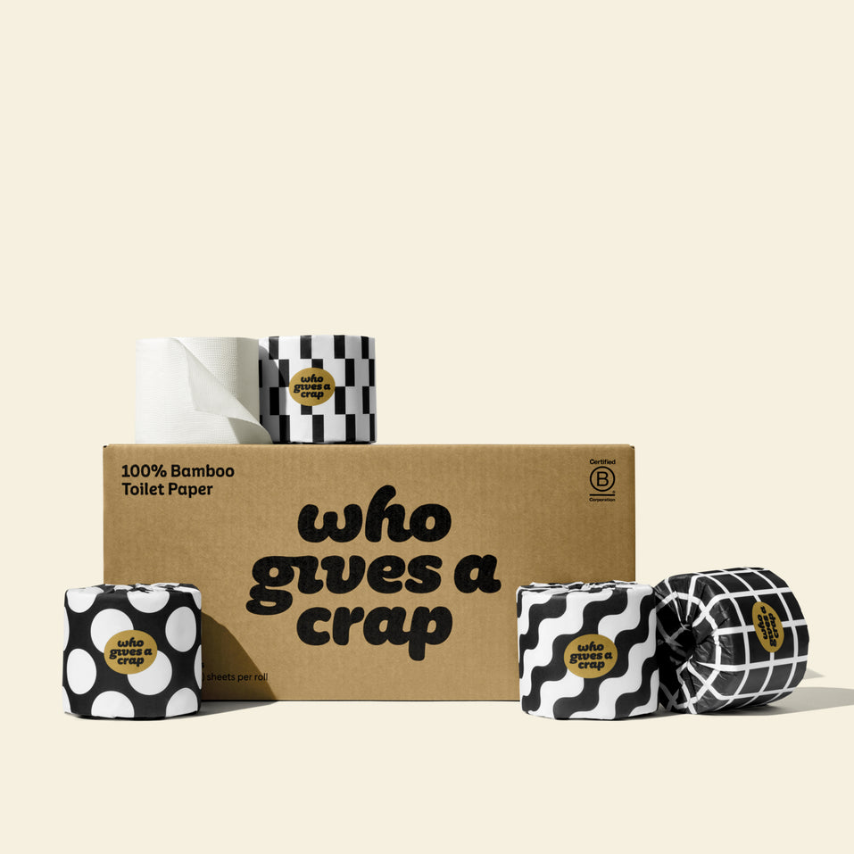 A medium box of Who Gives A Crap 100% Bamboo Toilet Paper with black and white wrappers - eco-friendly, biodegradable and sustainable toilet paper 