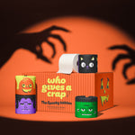 The Spooky Edition box of bamboo toilet paper with pumpkin, vampire, cat and Frankenstein rolls, lit by spooky hand shadows