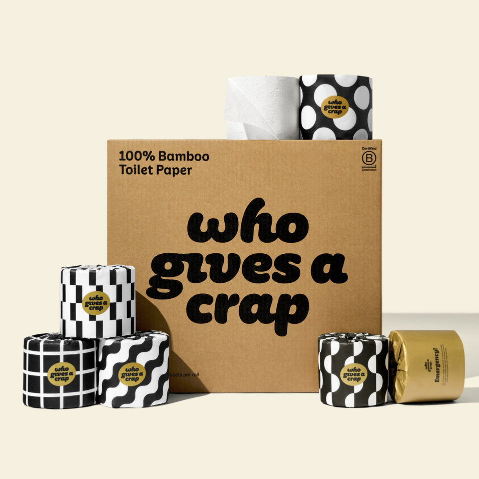 A large box of Who Gives A Crap 100% Bamboo Toilet Paper with black and white wrappers - eco-friendly, biodegradable and sustainable toilet paper