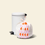 Who Gives a Crap large recycled garbage bag sits full next to kitchen bin