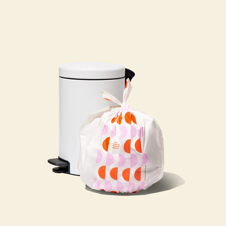 Who Gives a Crap large recycled garbage bag sits full next to kitchen bin