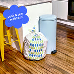 Who Gives a Crap large recycled garbage bag sits full next to kitchen bin. Caption in corner reads ‘Leak & tear resistant’.
